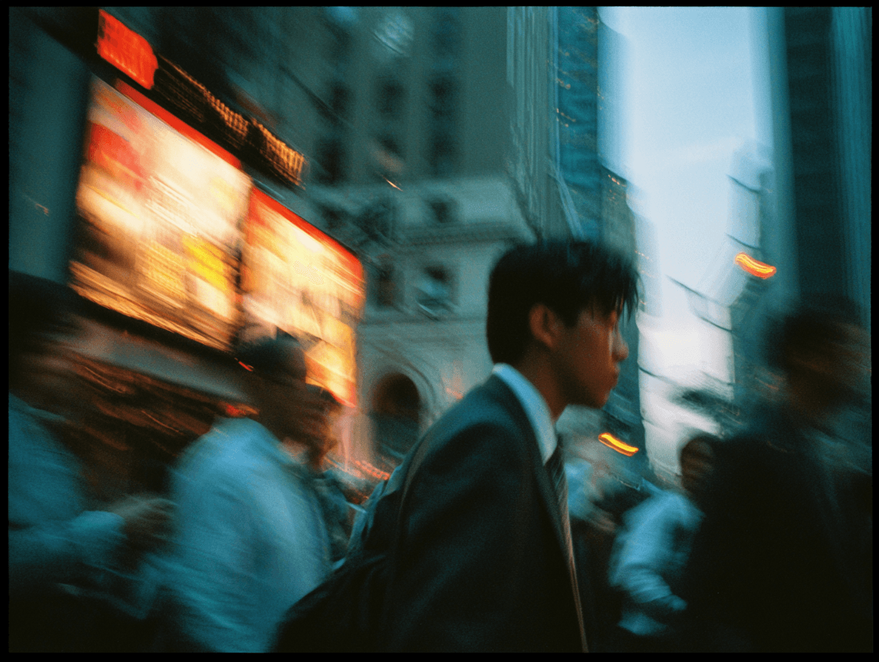 A professional walking through a city street at dusk, illuminated by neon signage